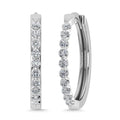 Pair of diamond hoop earrings on a white background