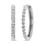 Pair of diamond hoop earrings on a white background