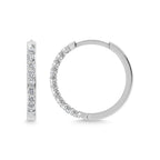 Silver hoop earrings with clear gemstones on a white background